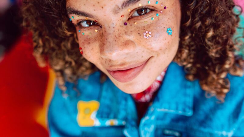 smiling person with glitter make-up
